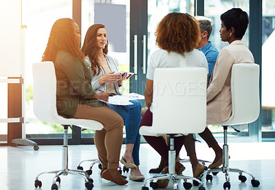 Buy stock photo Shot of a businesswoman looking confused during meeting with her colleagues modern office