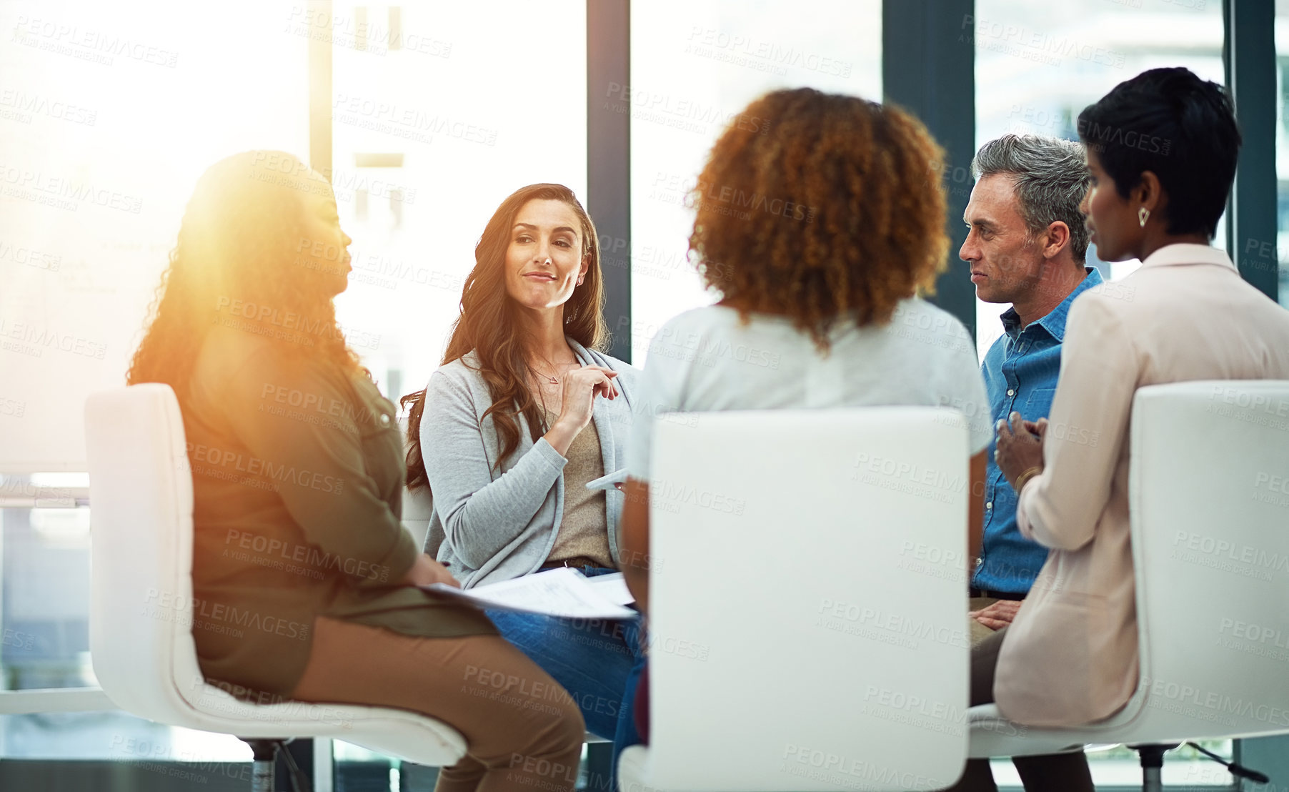 Buy stock photo Shot of a team of colleagues having a meeting in a modern office