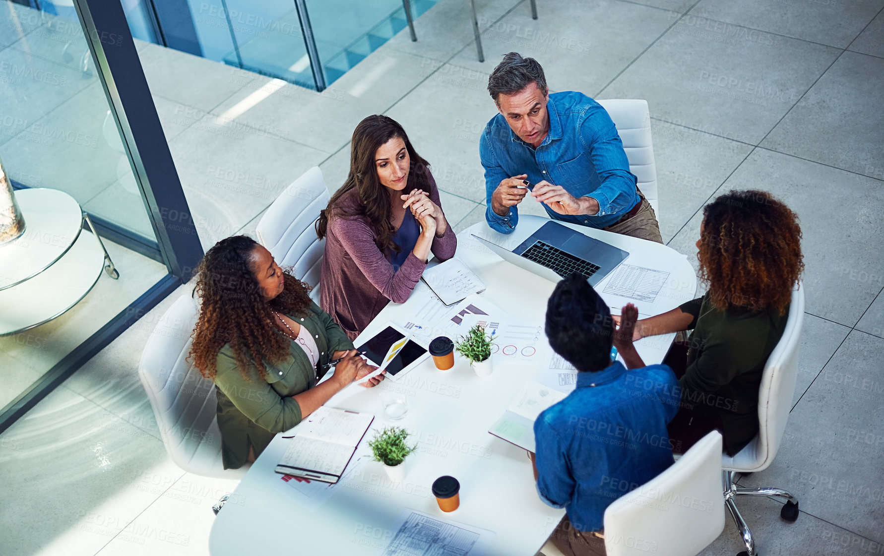 Buy stock photo High angle shot of a group of designers having a meeting in an office