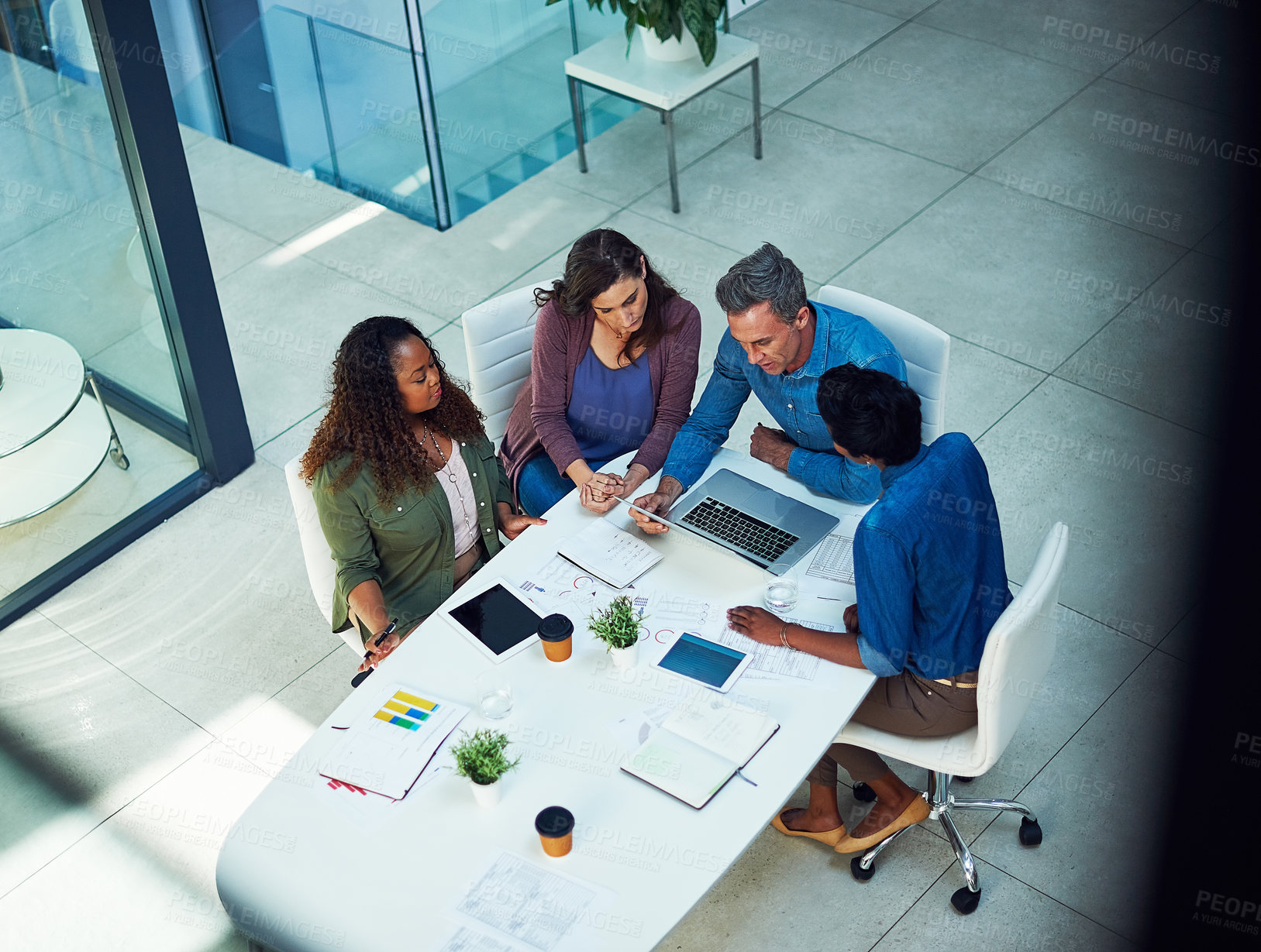 Buy stock photo High angle shot of a group of designers having a meeting in an office