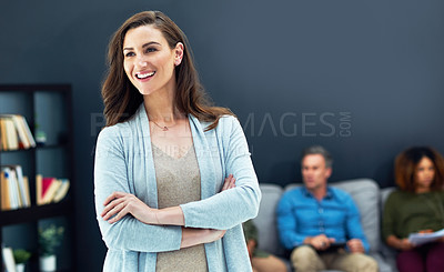 Buy stock photo Shot of a confident young businesswoman with her team blurred in the background