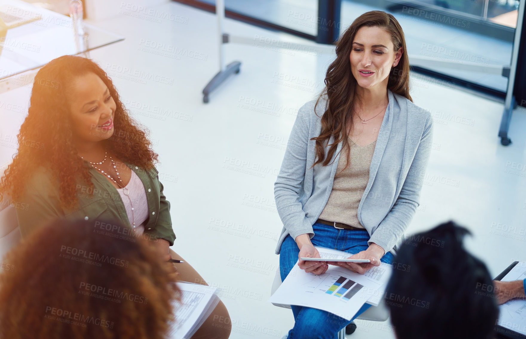 Buy stock photo Shot of a team of colleagues having a meeting in a modern office