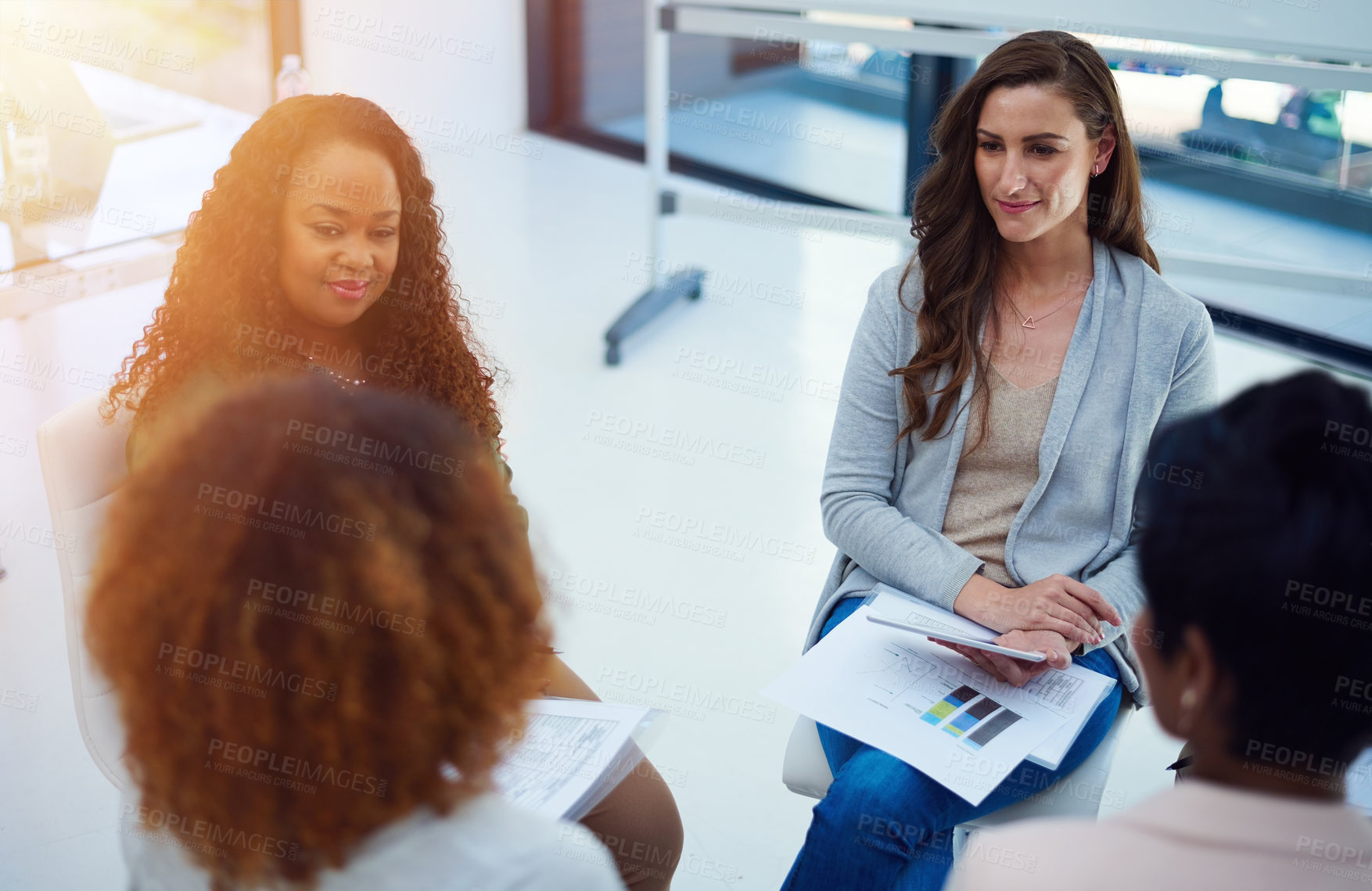 Buy stock photo Shot of a team of colleagues having a meeting in a modern office