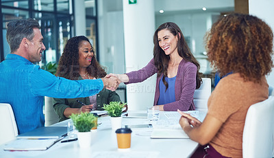 Buy stock photo Shot of two designers shaking hands during a meeting