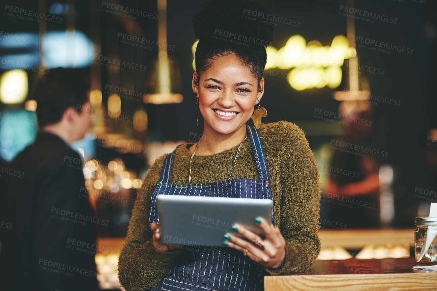 Buy stock photo Shot of a young woman using a  digital tablet while working at a coffee shop