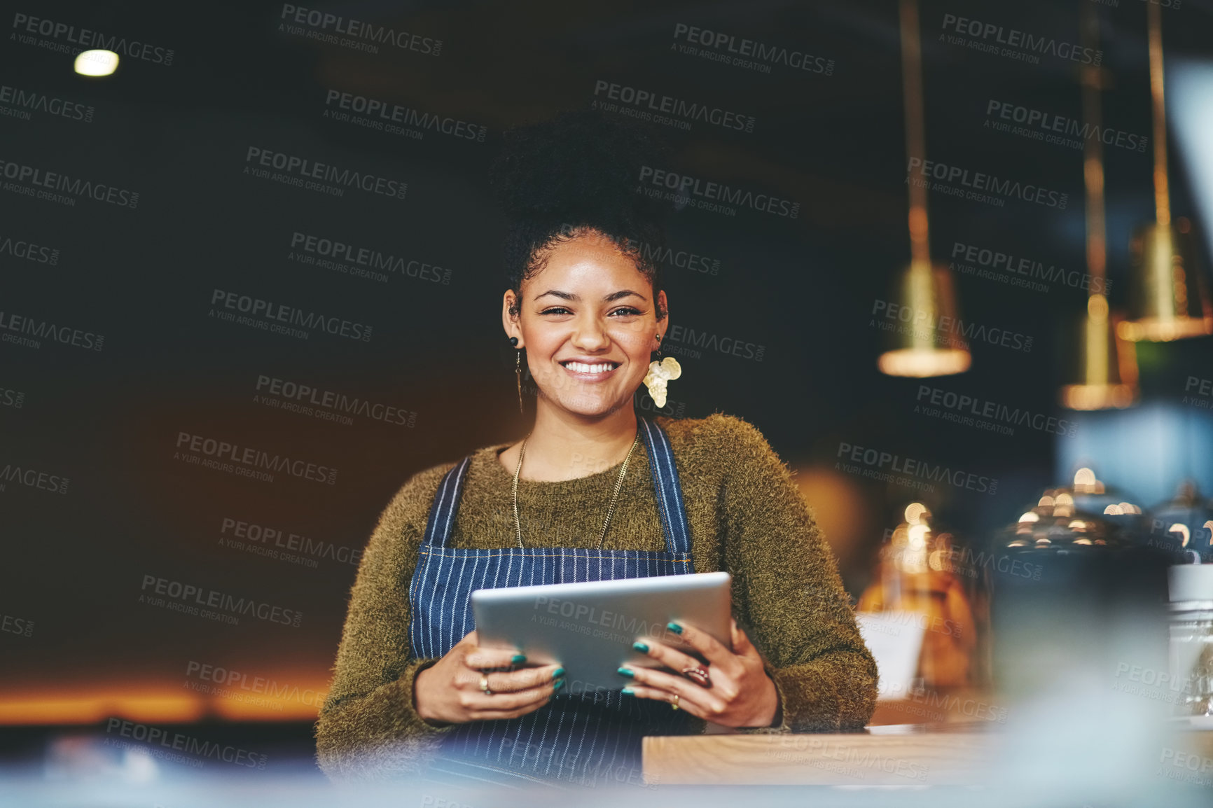 Buy stock photo Shot of a young woman using a  digital tablet while working at a coffee shop