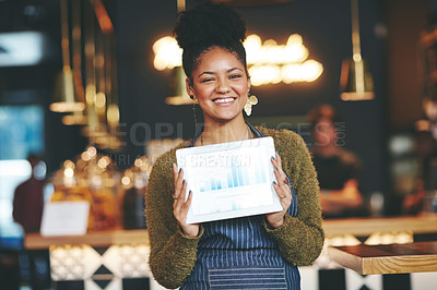Buy stock photo Shot of a young woman holding a digital tablet with a graph on the screen at a coffee shop