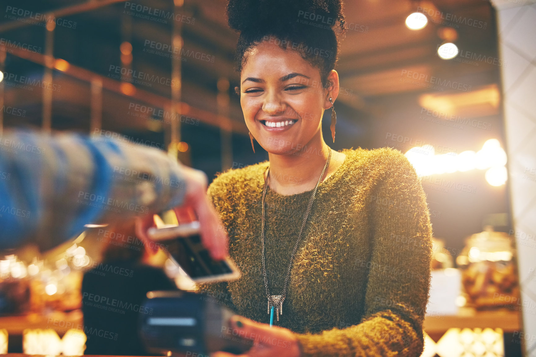 Buy stock photo Shot of a waitress accepting a NFC payment from a customer in a cafe