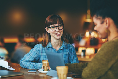 Buy stock photo Shot of two young friends hanging out together in a cafe