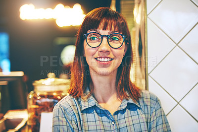 Buy stock photo Shot of a young business owner looking thoughtful while standing in her cafe