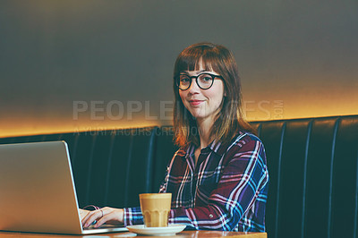 Buy stock photo Portrait of an attractive young woman using her laptop in a cafe