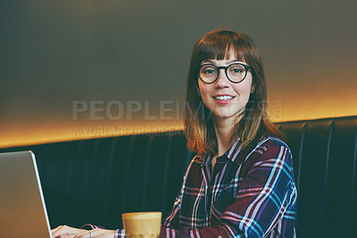 Buy stock photo Portrait of an attractive young woman using her laptop in a cafe