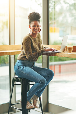 Buy stock photo Portrait of an attractive young woman using her laptop in a cafe
