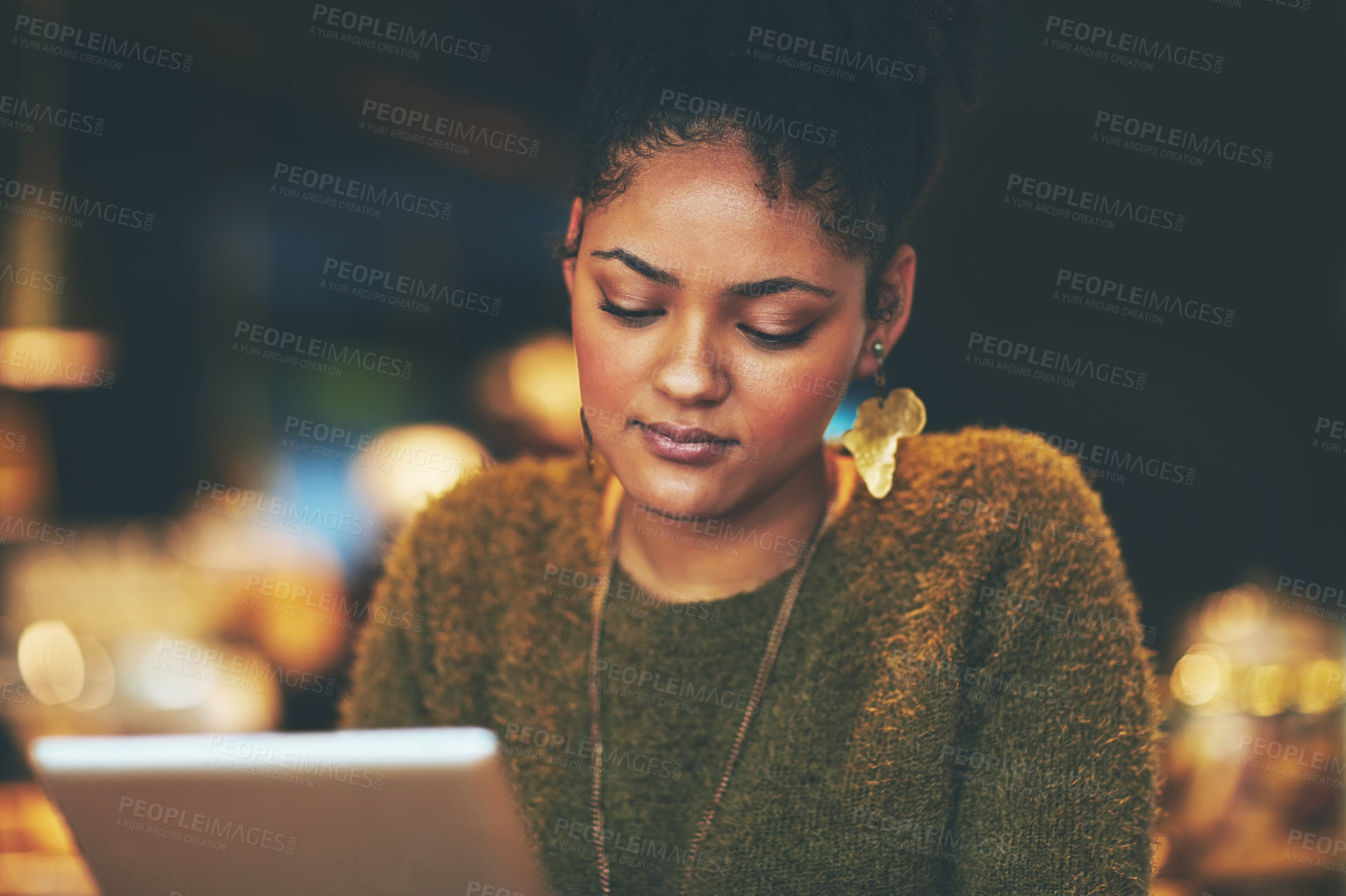 Buy stock photo Shot of an attractive young woman using a digital tablet in a cafe