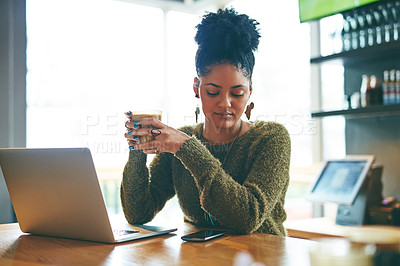 Buy stock photo Cropped shot of an attractive young woman using her laptop in a cafe