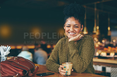 Buy stock photo Portrait of an attractive young woman enjoying a cup of coffee in a cafe