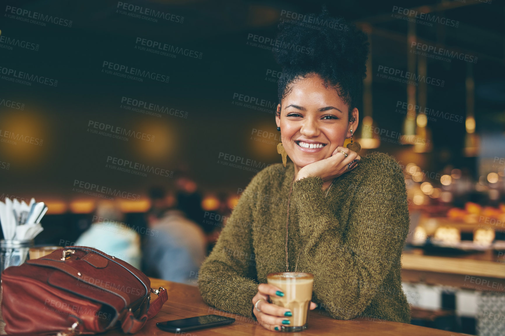 Buy stock photo Portrait of an attractive young woman enjoying a cup of coffee in a cafe