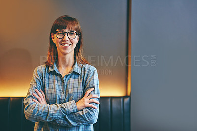 Buy stock photo Portrait of an attractive young woman standing with her arms crossed