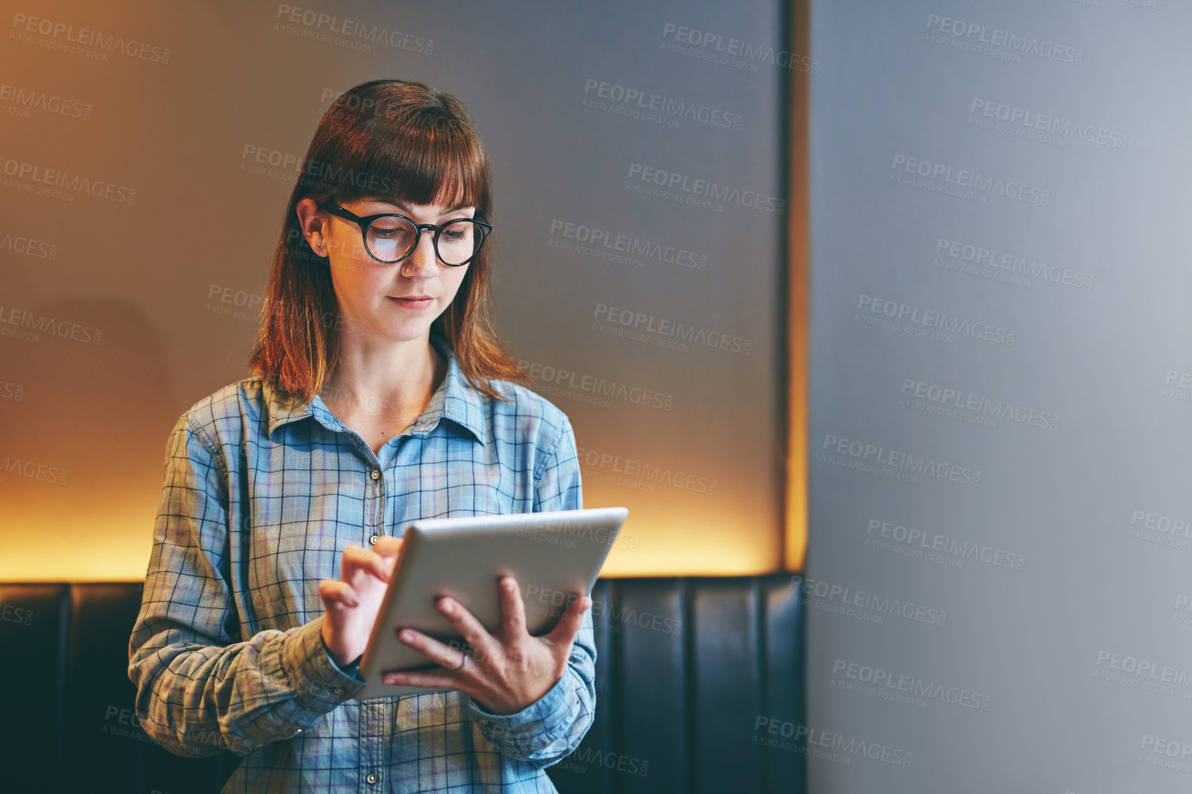 Buy stock photo Tablet, typing and woman in communication with reading, article review and feedback for late deadline. Night, web research or creative writing with tech, connectivity and information for blog