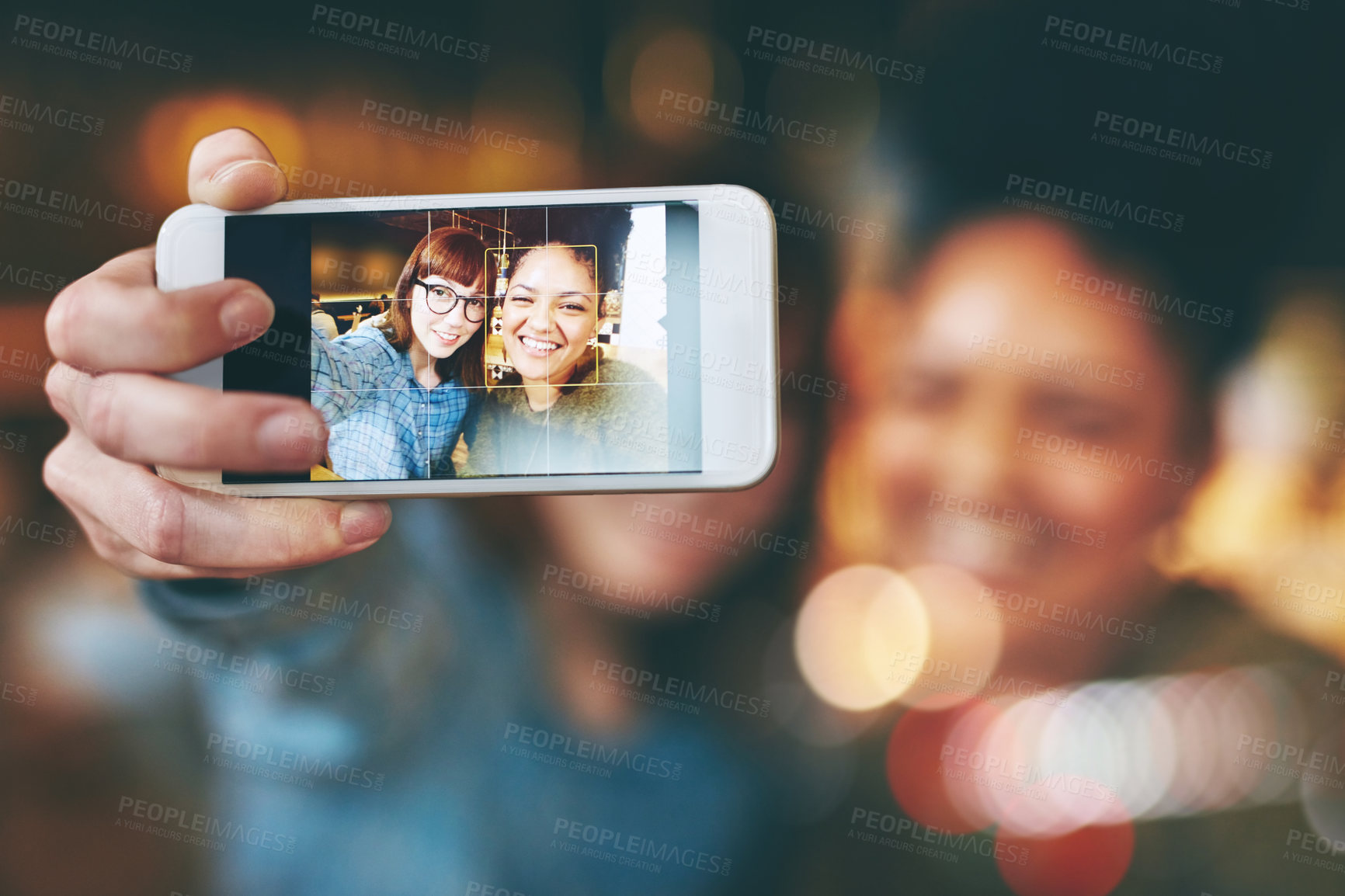 Buy stock photo Shot of two young friends taking a selfie together in a cafe