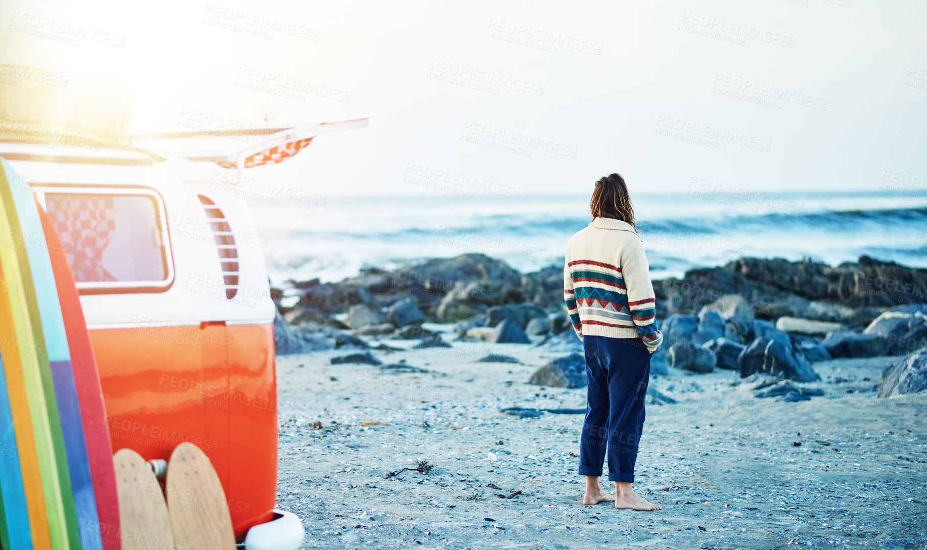 Buy stock photo Rearview shot of a young man stopping at the beach during a roadtrip