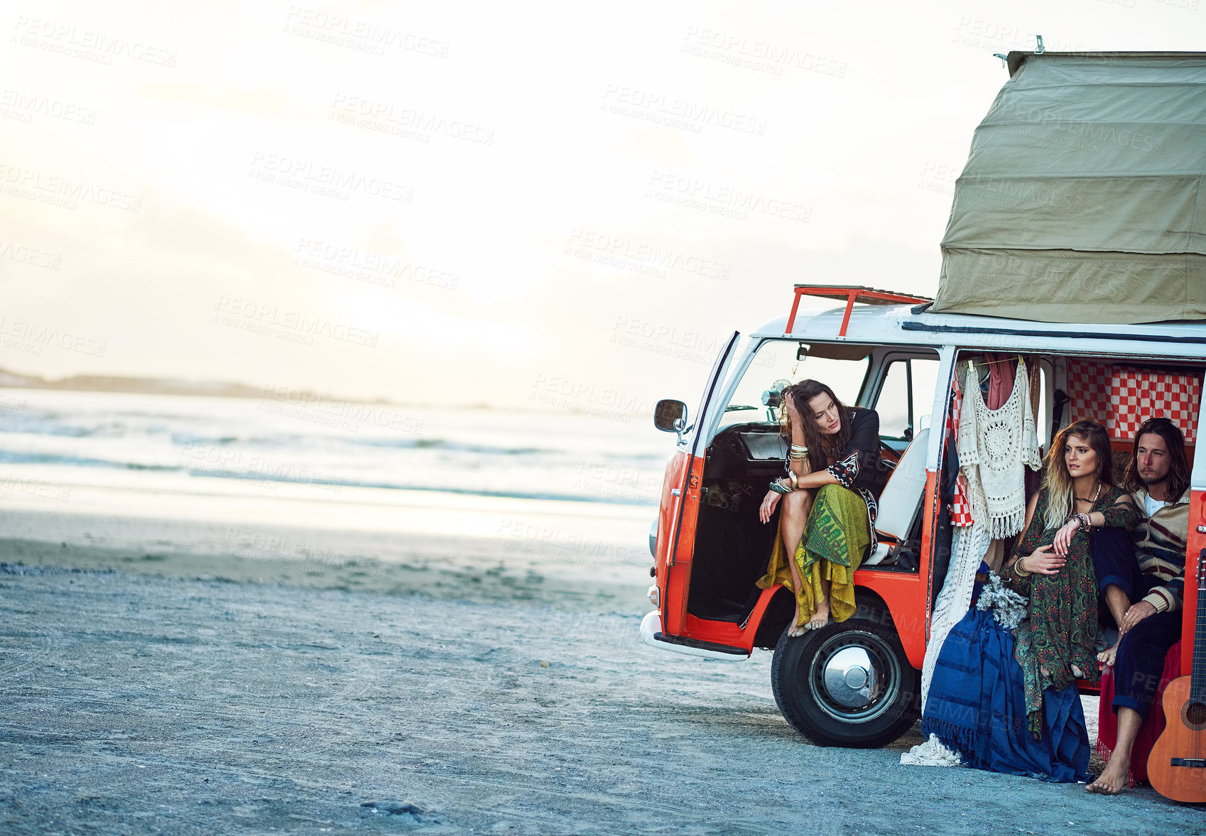 Buy stock photo Shot of a group of young friends stopping at the beach during a roadtrip