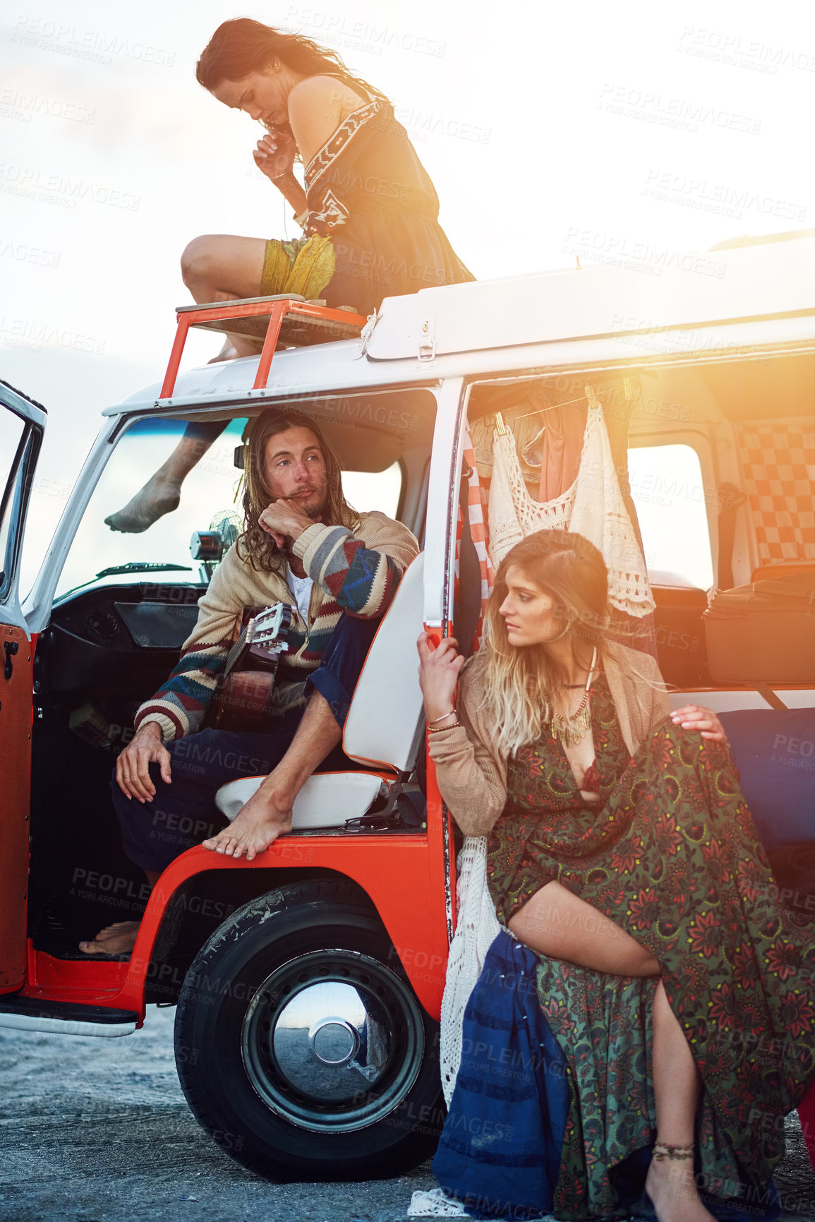 Buy stock photo Shot of a group of young friends stopping at the beach during a roadtrip