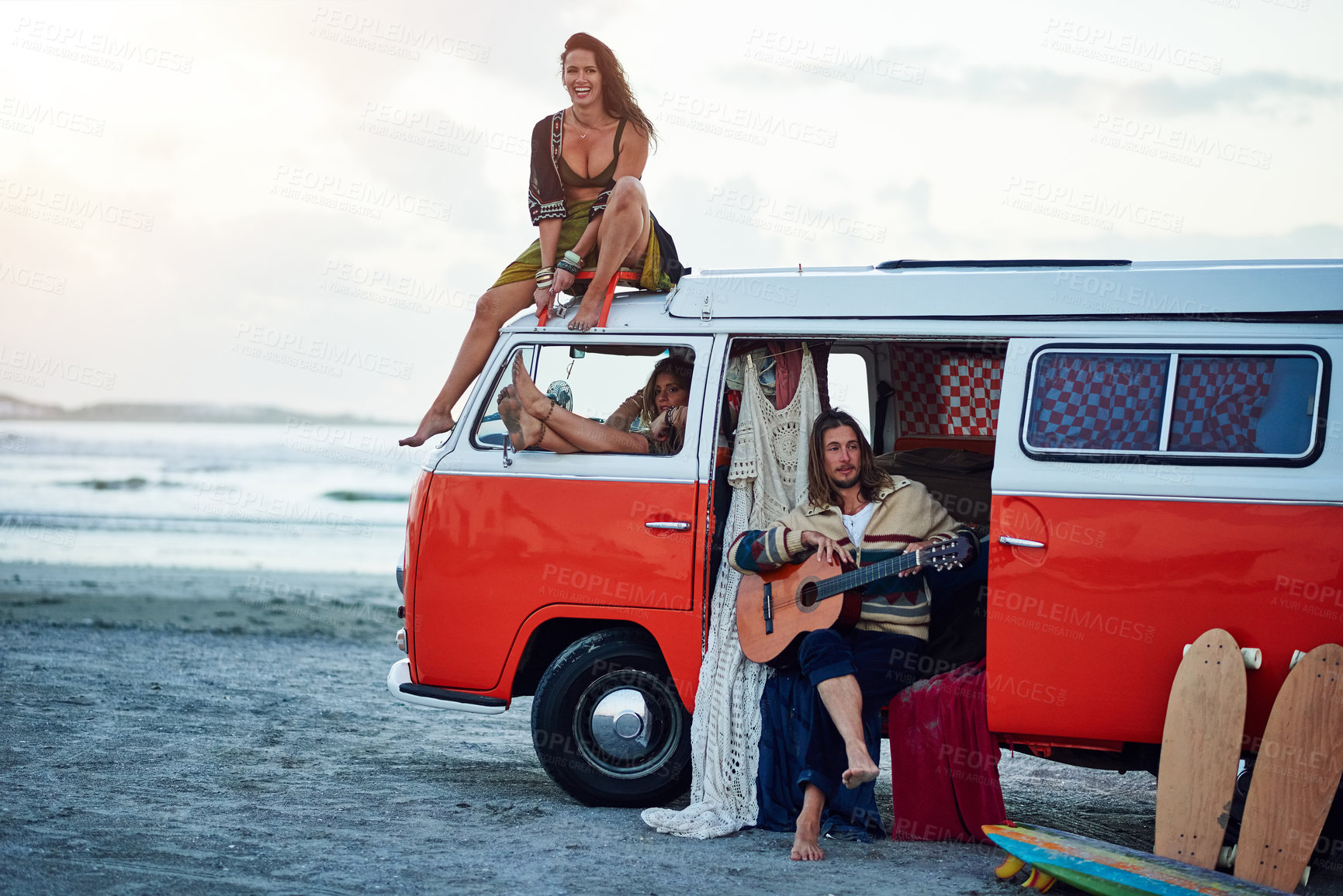 Buy stock photo Shot of a group of young friends stopping at the beach during a roadtrip