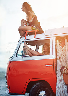 Buy stock photo Shot of a two young girlfriends stopping at the beach during a roadtrip