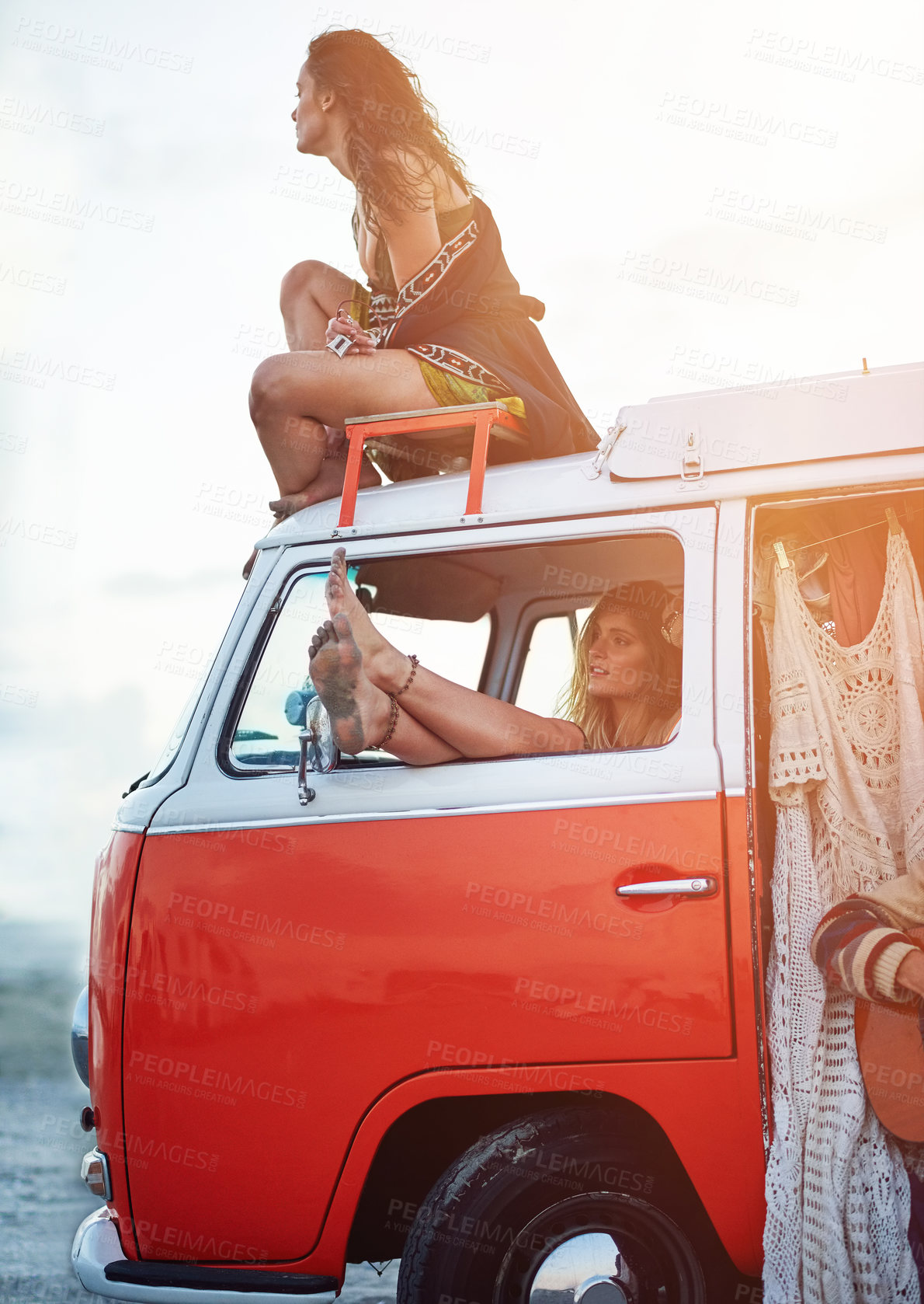 Buy stock photo Shot of a two young girlfriends stopping at the beach during a roadtrip