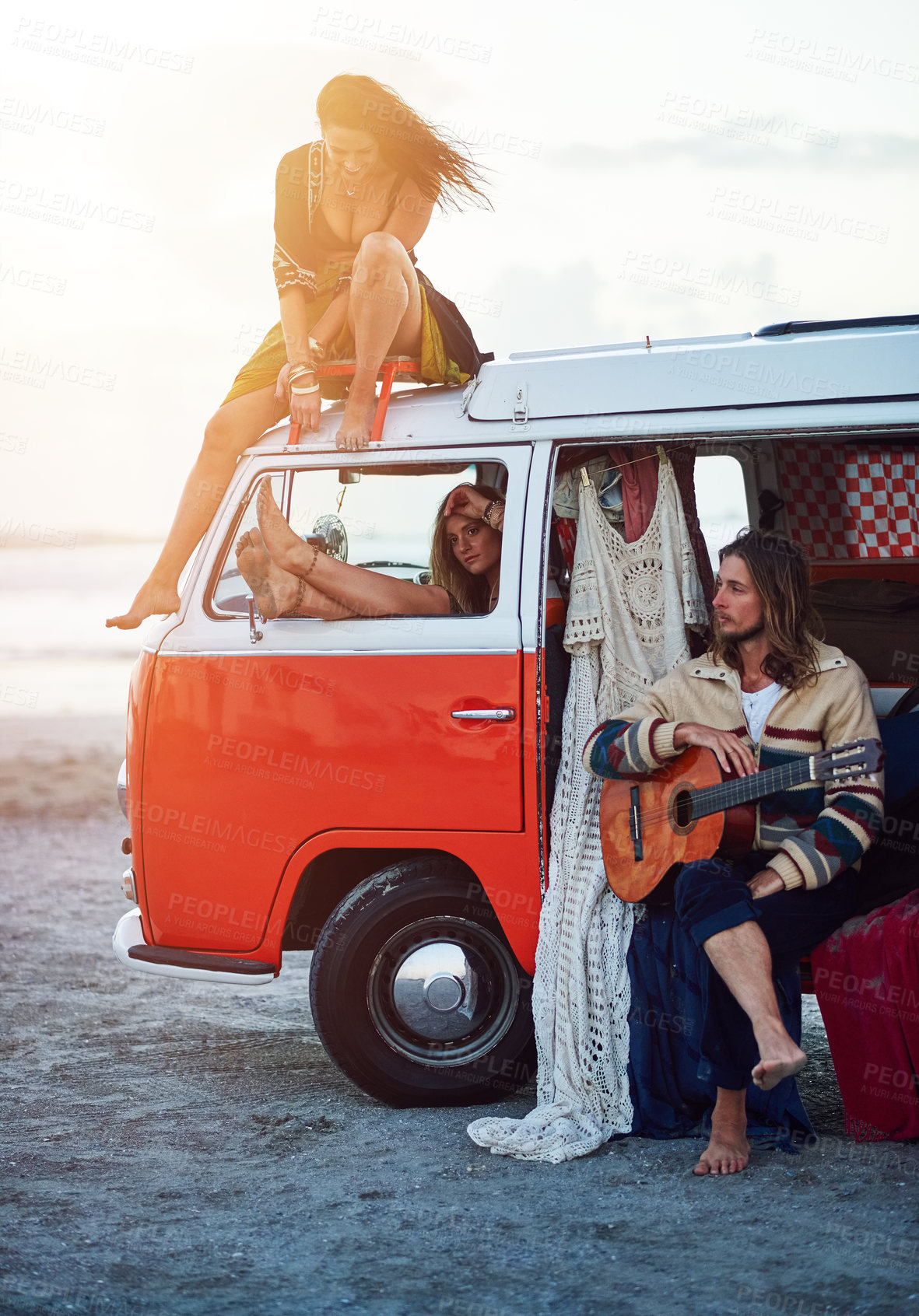 Buy stock photo Shot of a group of young friends stopping at the beach during a roadtrip