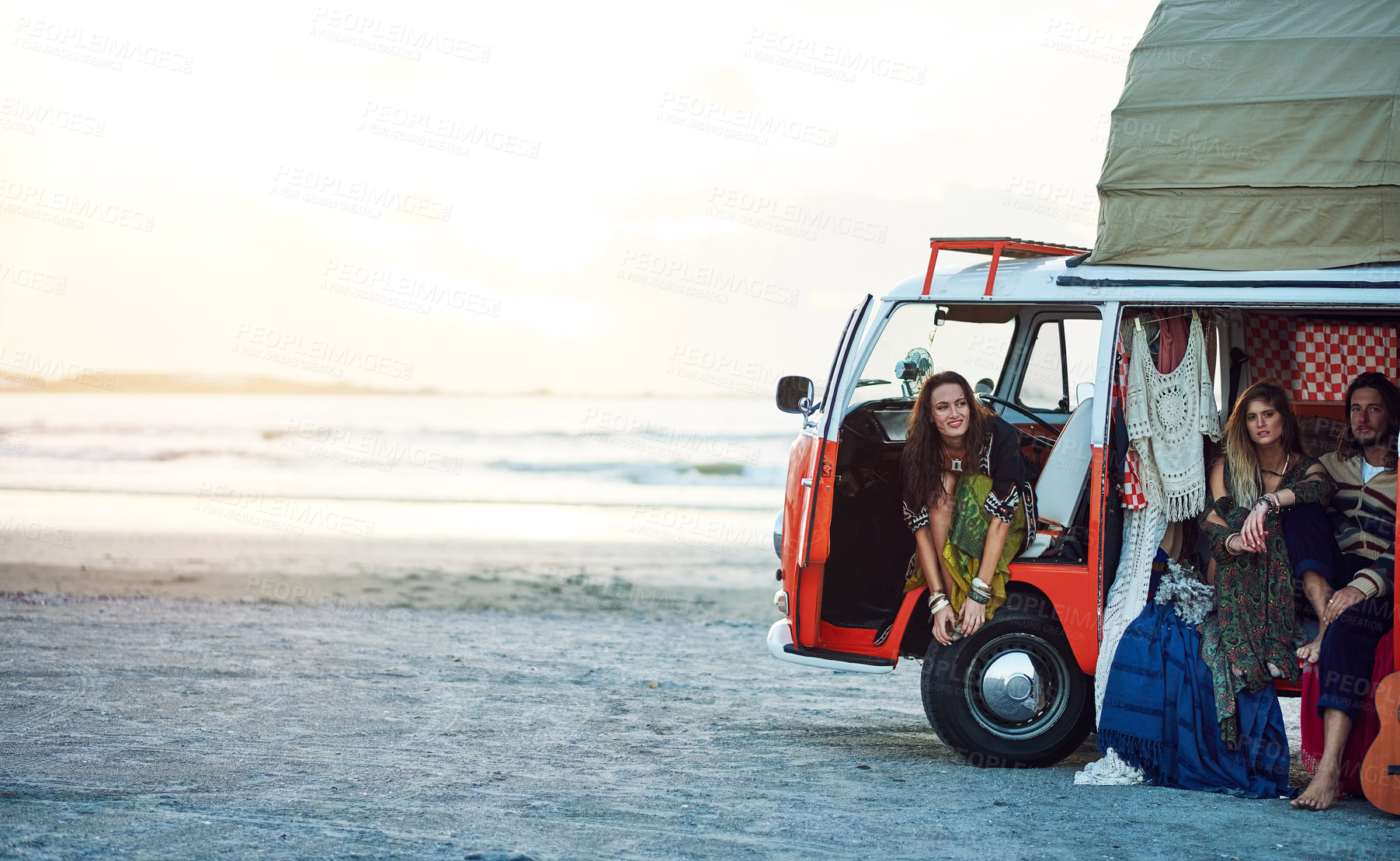 Buy stock photo Shot of a group of young friends stopping at the beach during a roadtrip