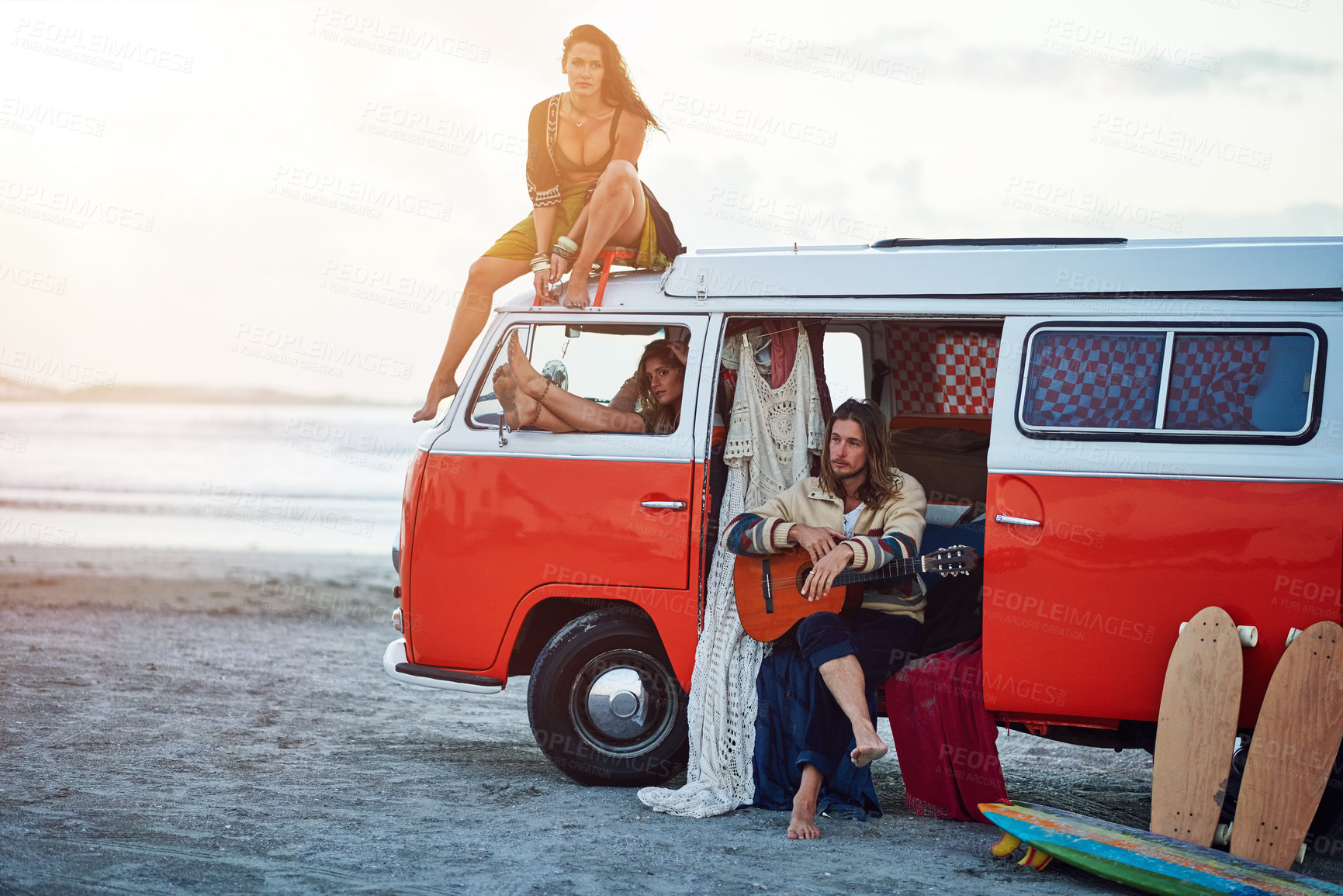 Buy stock photo Shot of a group of young friends stopping at the beach during a roadtrip