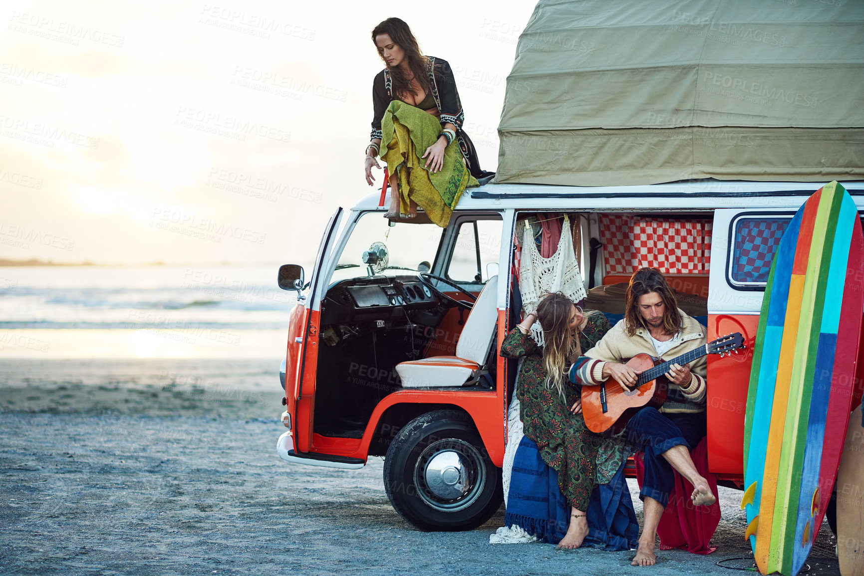 Buy stock photo Shot of a group of young friends stopping at the beach during a roadtrip