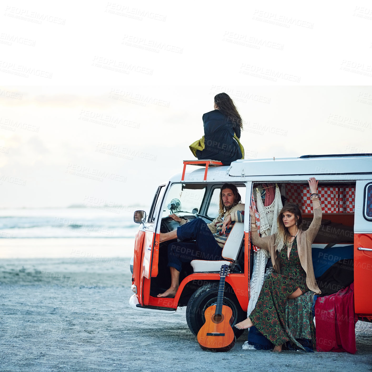 Buy stock photo Shot of a group of young friends stopping at the beach during a roadtrip