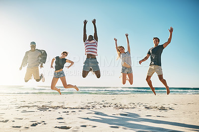 Buy stock photo Shot of a group of young friends jumping enthusiastically in the air at the beach