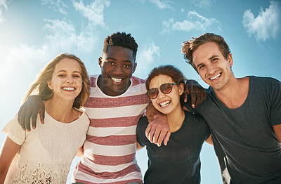 Buy stock photo Shot of a happy group of friends enjoying a day together outdoors