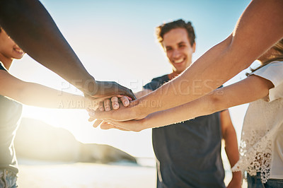 Buy stock photo Cropped shot of a group of young joining their hands together in solidarity