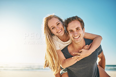 Buy stock photo Portrait, piggy back and beach with couple, smile and sunshine with happiness, honeymoon and romance. Face, seaside and man carrying woman with vacation, journey and summer with getaway trip or love