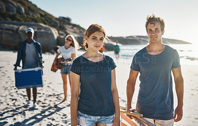 Buy stock photo Portrait of a group of young friends walking on the beach on a sunny day