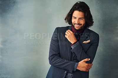 Buy stock photo Studio shot of a stylishly dressed handsome young man standing with his arms crossed