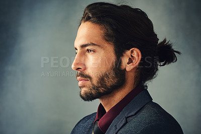 Buy stock photo Studio profile shot of a stylishly dressed handsome young man with a ponytail