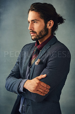 Buy stock photo Studio shot of a stylishly dressed handsome young man standing with his arms crossed