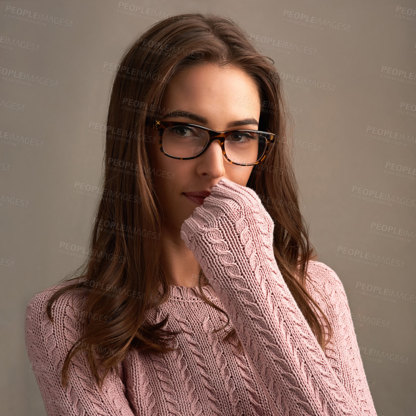 Buy stock photo Shot of a beautiful young woman posing against a brown background