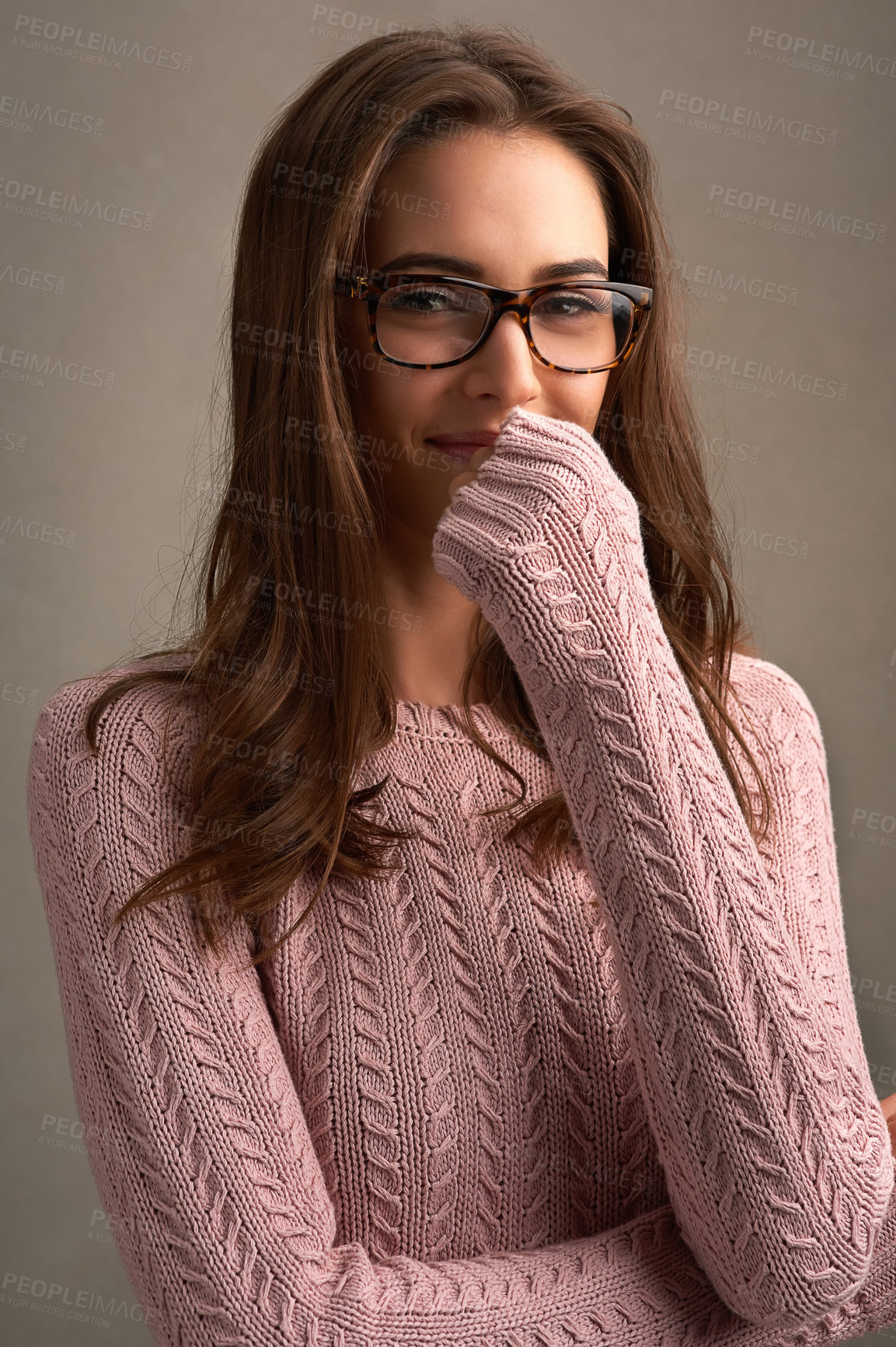 Buy stock photo Shot of a beautiful young woman posing against a brown background