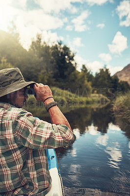 Buy stock photo Travel, man and kayak with binocular on lake for nature observation, camping adventure and hiking activity. Male person, water and explore with field glasses for watching wildlife and scenic view.