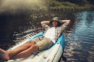Buy stock photo Portrait of a young man enjoying a canoe ride on the lake