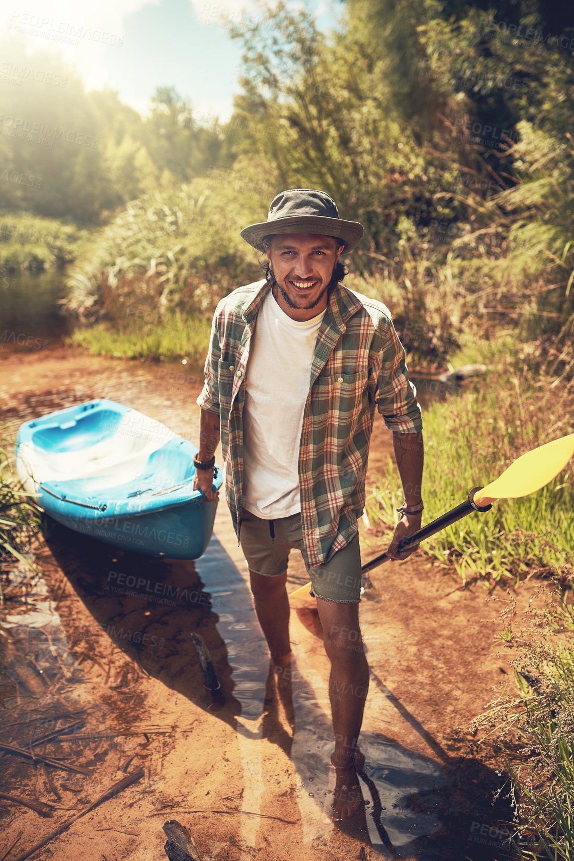 Buy stock photo Portrait, man and smile by river with kayak for adventure, travel and camping or trekking. Nature, hiking and boat or happy male person outdoor for vacation or holiday by lake for journey or freedom