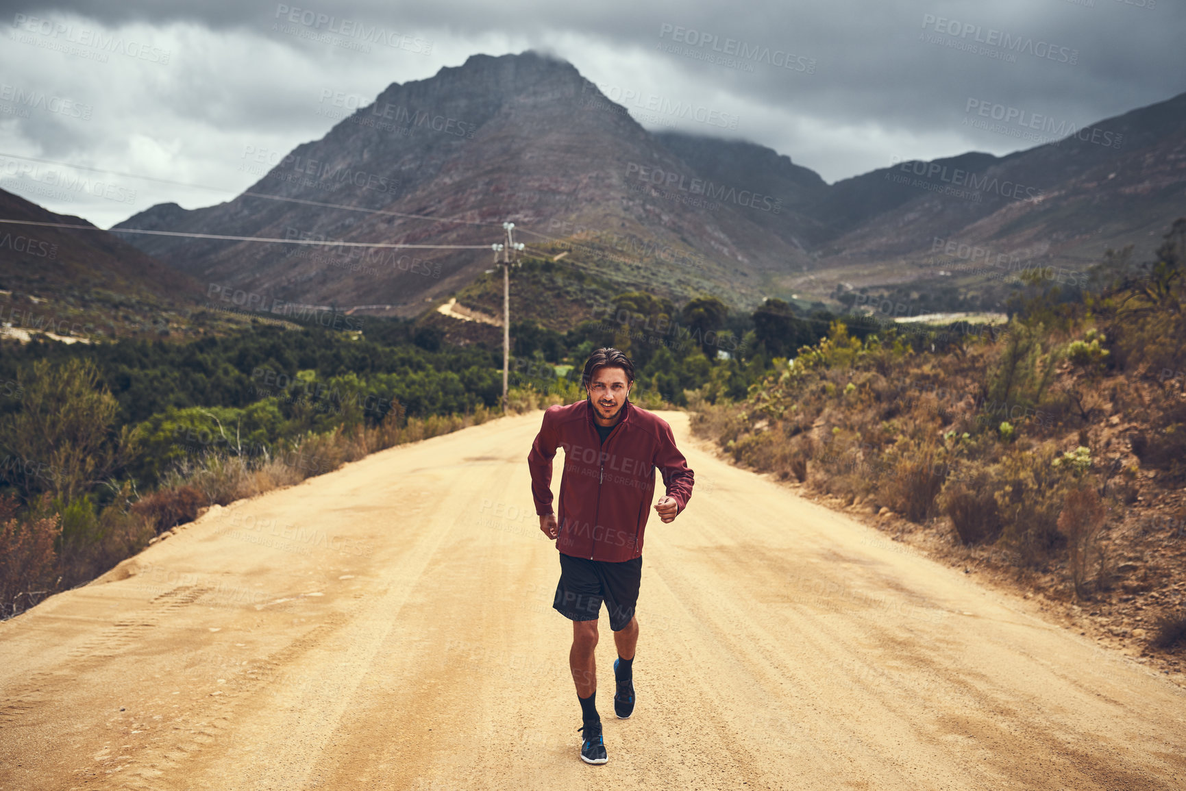 Buy stock photo Fitness, portrait and man in nature for running, exercise and sports adventure in Switzerland. Outdoor, dirt road and clouds with male runner for challenge, training and practice for marathon