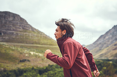 Buy stock photo Cropped shot of a young man out for a trail run